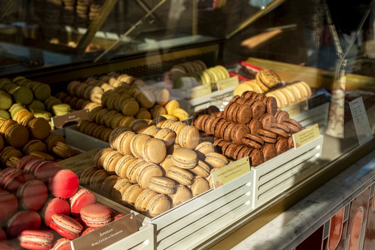 Vibrant assortment of macarons showcased in a Paris storefront capturing the essence of French patisserie.